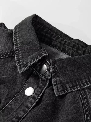 Black denim button-up dress with a collared neckline and silver snap buttons.