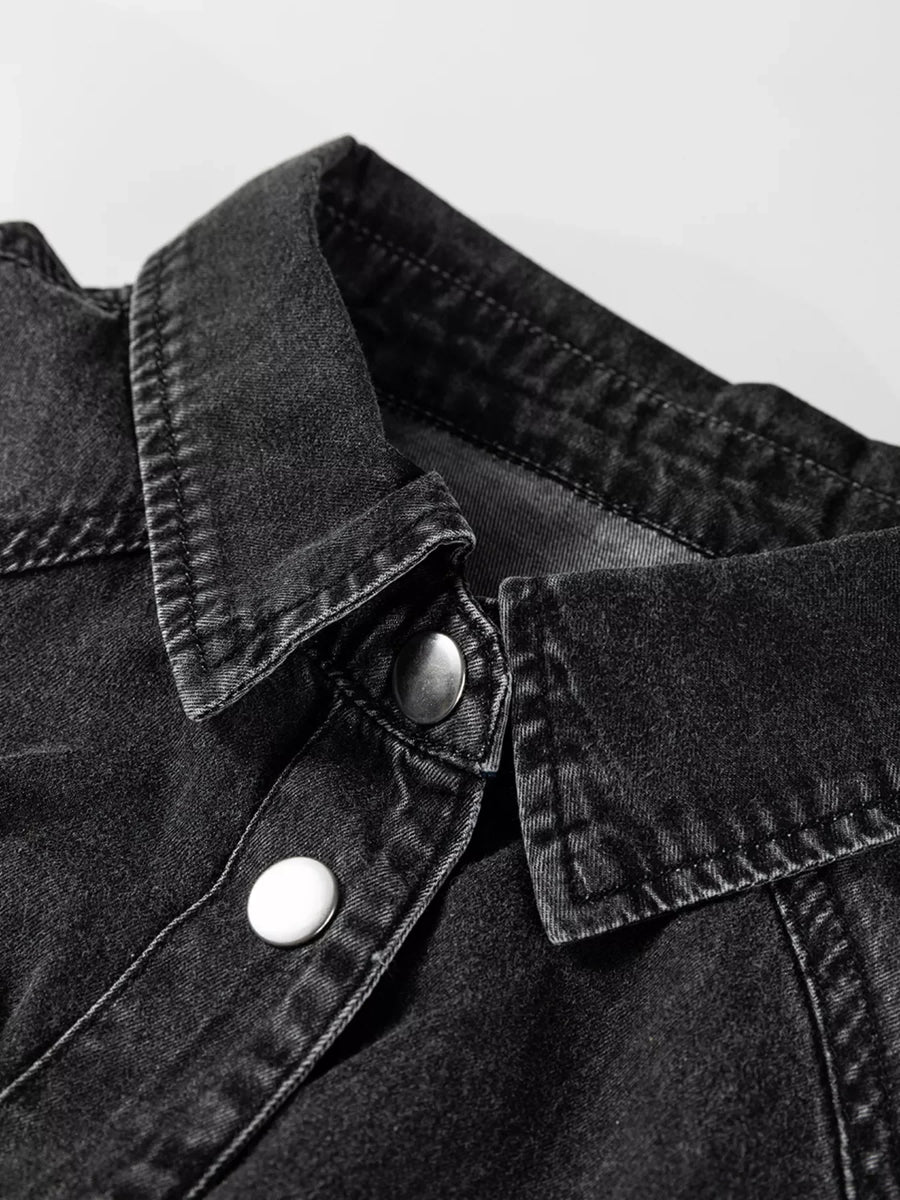 Black denim button-up dress with a collared neckline and silver snap buttons.