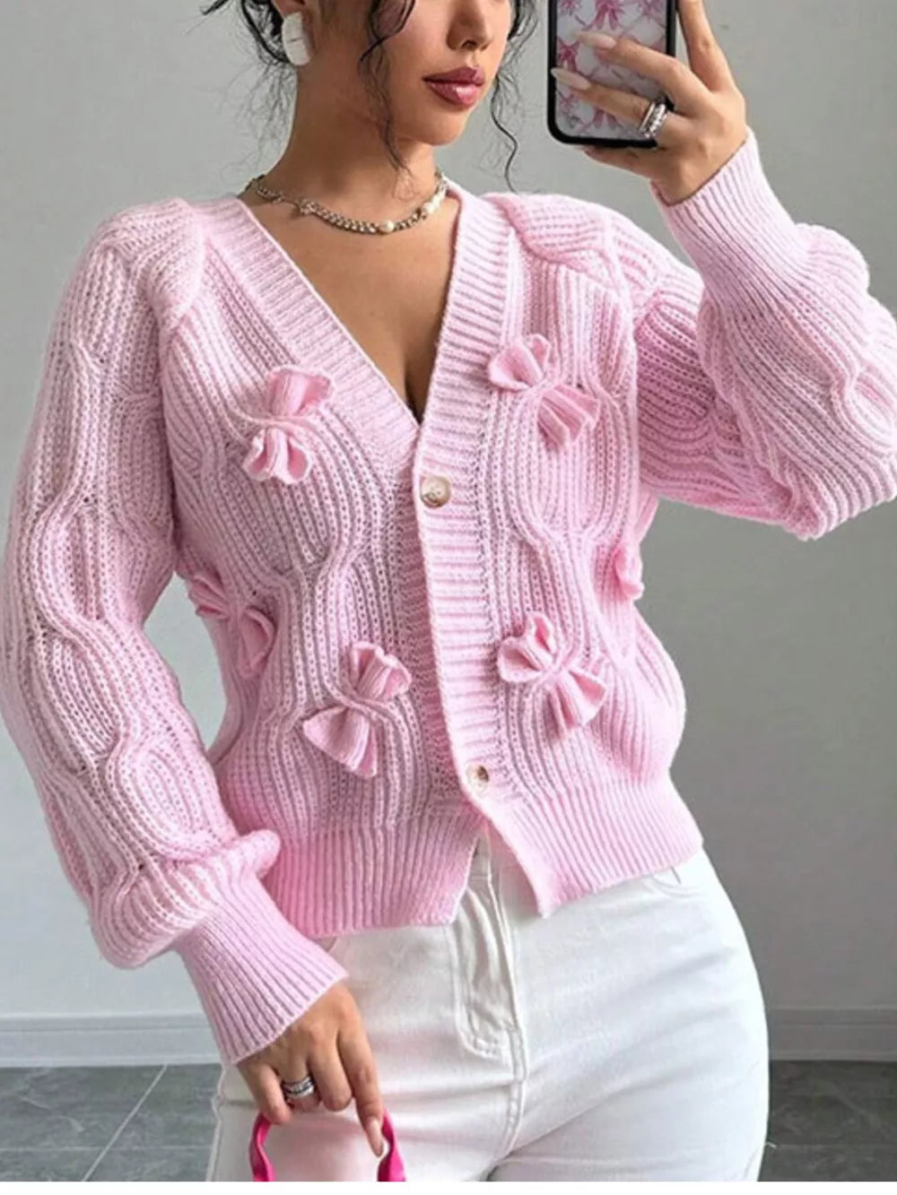 light pink cardigan with cable knit and v-neck