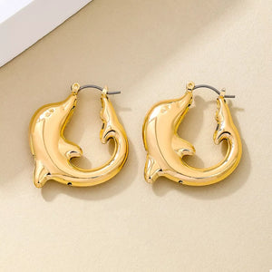 Gold dolphin hoop earrings with a polished finish.