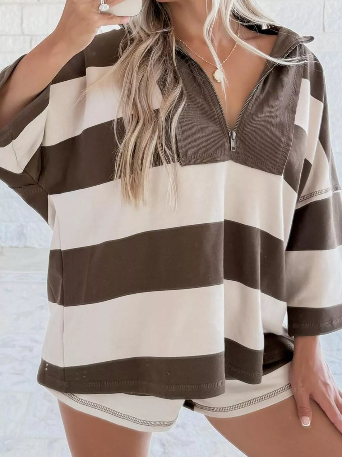 Quarter-zip sweatshirt in chocolate and cream stripes with a relaxed fit and a zippered neckline.