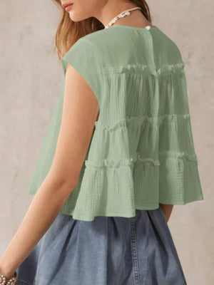 Green tiered ruffle blouse with short sleeves and a relaxed fit.