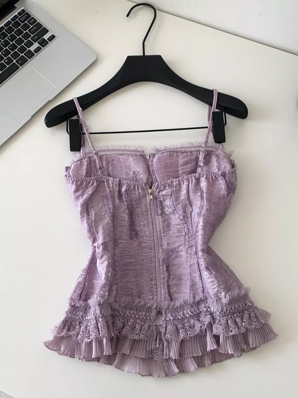 Purple lace ruffle hem tank top with front zipper and textured fabric.