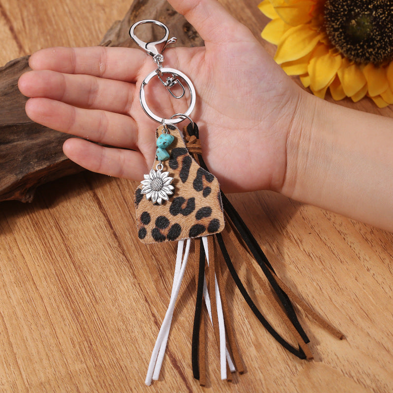Leopard print tag keychain with flower charm, turquoise beads, and multi-color tassels.