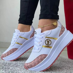 White round toe platform sneakers with pink monogram pattern and gold accents.
