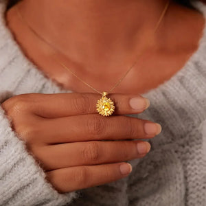 Gold sunflower pendant necklace with yellow center stone on a delicate chain