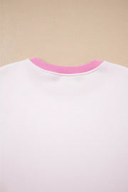 White cotton sweatshirt with pink ribbed crew neck detail.