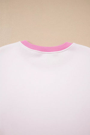 White cotton sweatshirt with pink ribbed crew neck detail.