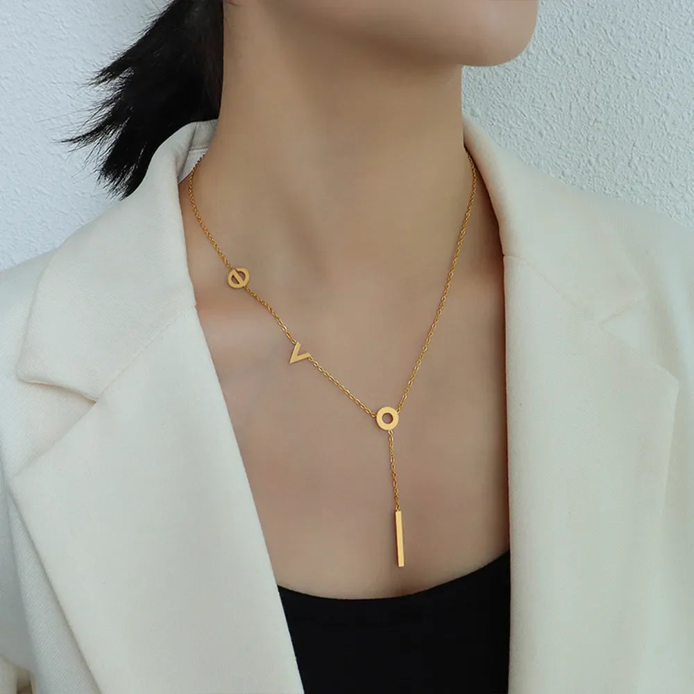 Gold Love Letter pendant necklace with 18K plating, featuring letter charms and a drop bar.