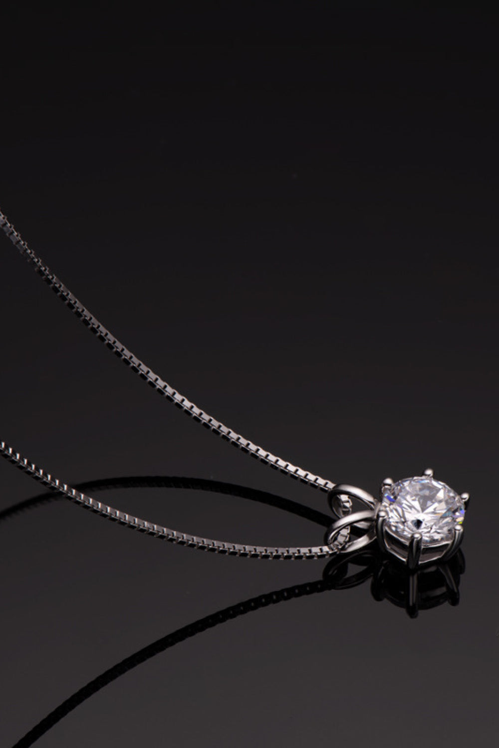 Silver moissanite pendant necklace with 1 carat round brilliant cut stone on 925 silver box chain.