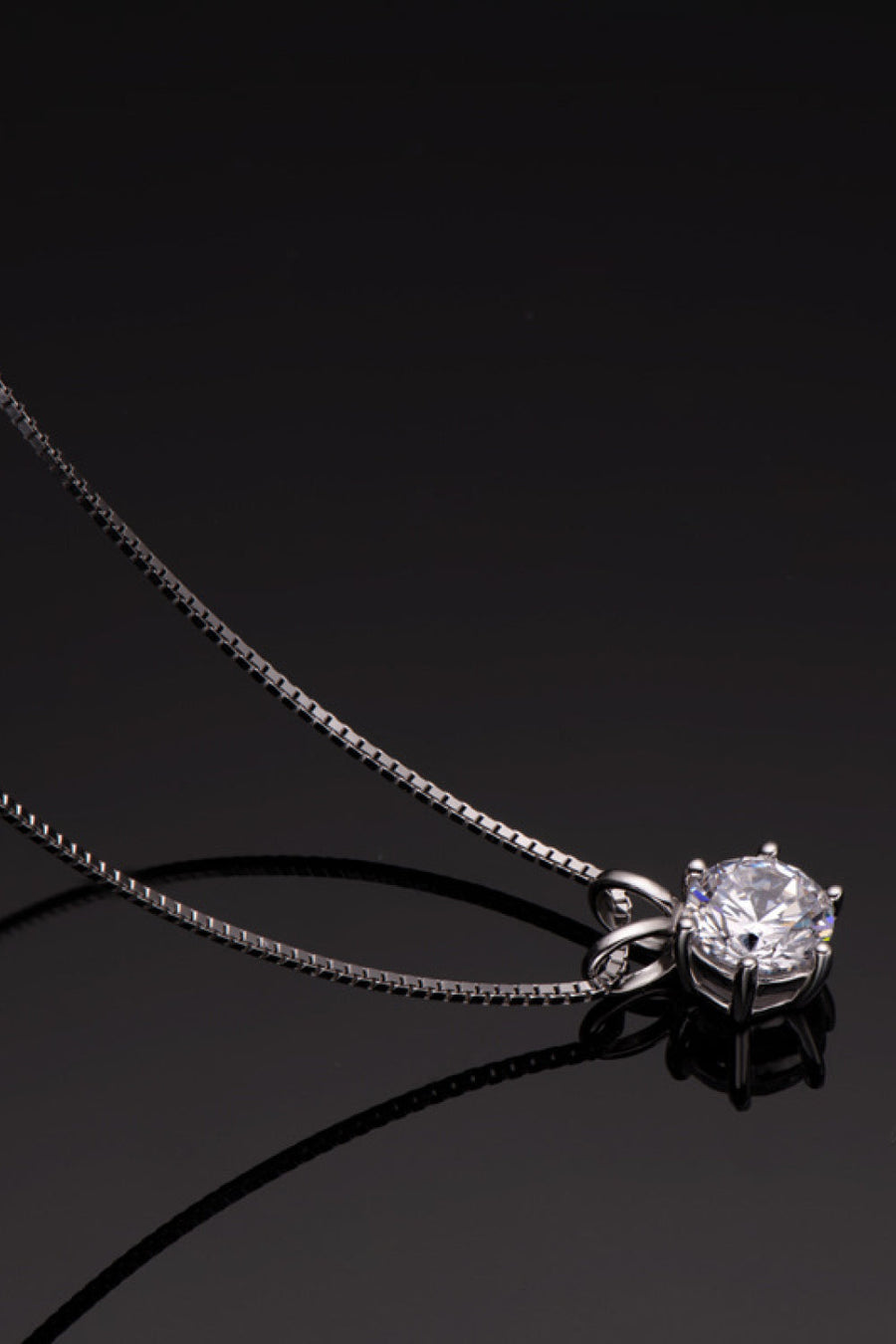 Silver moissanite pendant necklace with 1 carat round brilliant cut stone on 925 silver box chain.