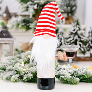 Festive gnome bottle topper with red and white striped hat and white faux fur beard.