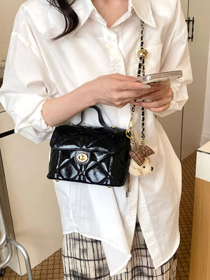 crossbody bag in black featuring quilted and boxy fit