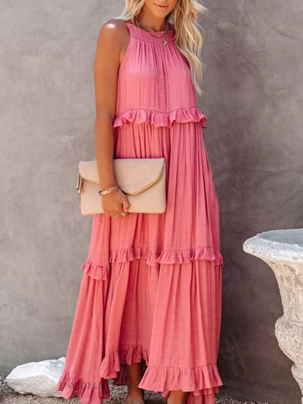 Pink ruffled maxi dress with halter neck and tiered skirt, polyester.
