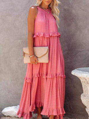 Pink ruffled maxi dress with halter neck and tiered skirt, polyester.