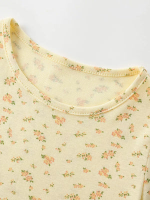 Yellow toddler dress with delicate pink floral print and short sleeves.
