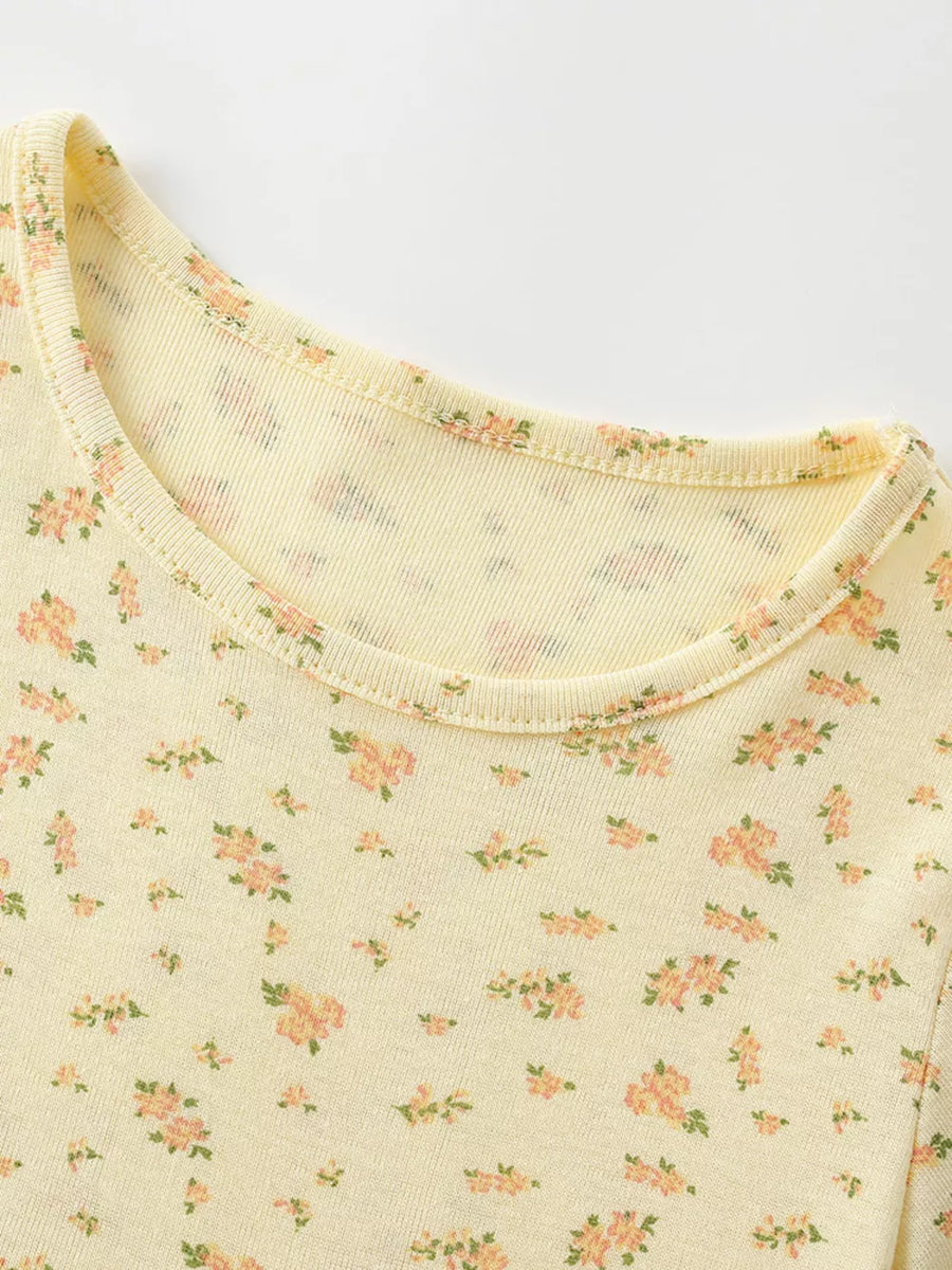 Yellow toddler dress with delicate pink floral print and short sleeves.