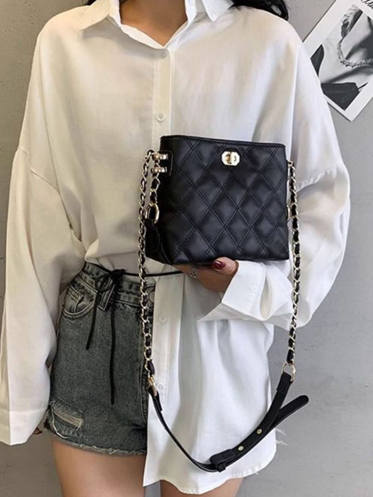 Black quilted pu leather crossbody bag with gold chain strap and turn-lock closure.