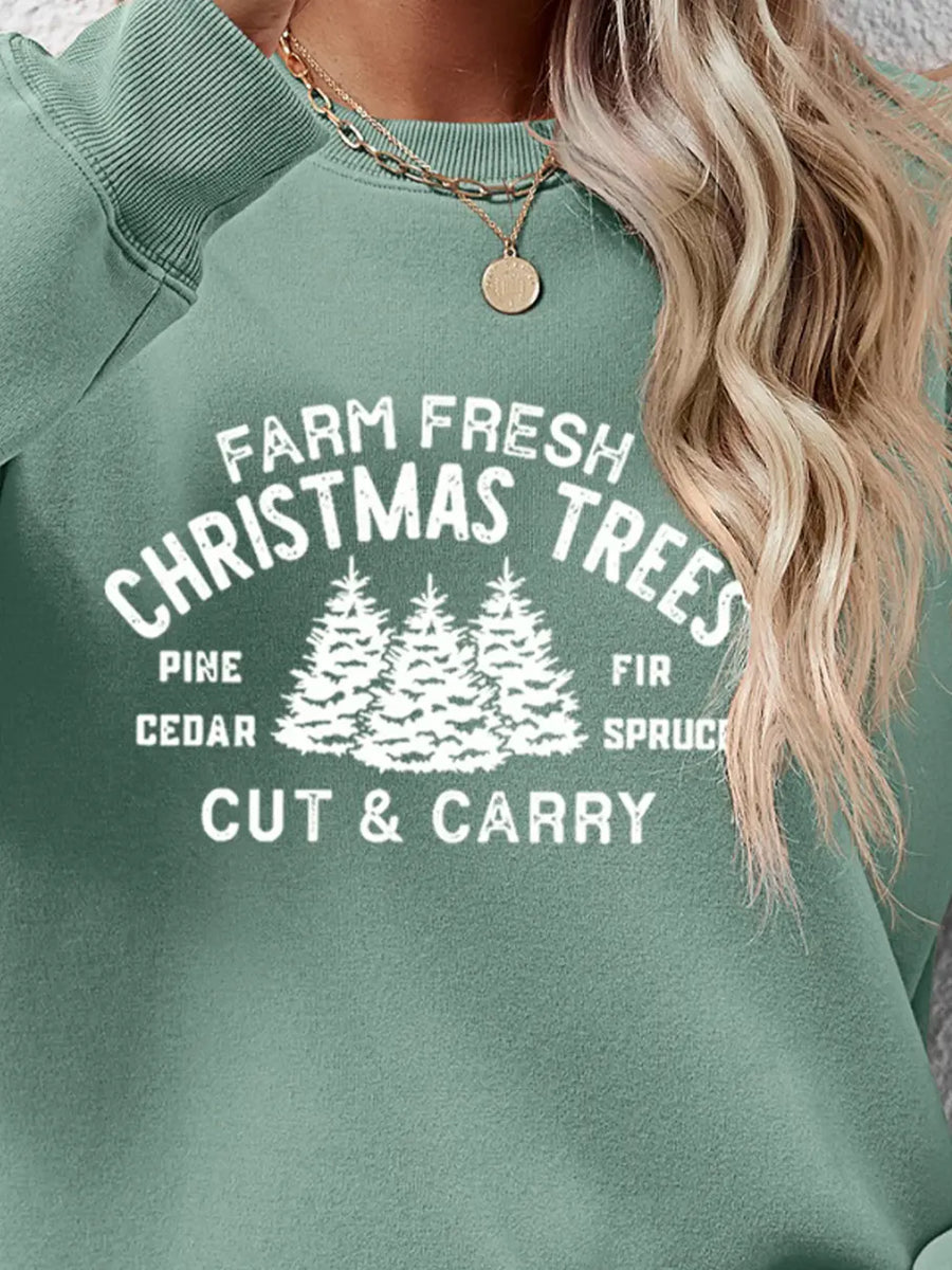 Green crewneck sweatshirt with "Farm Fresh Christmas Trees" graphic print and trees.