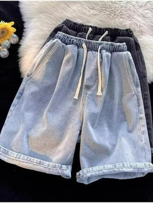 Men's light wash relaxed fit denim shorts with drawstring waist and cuffed hems.