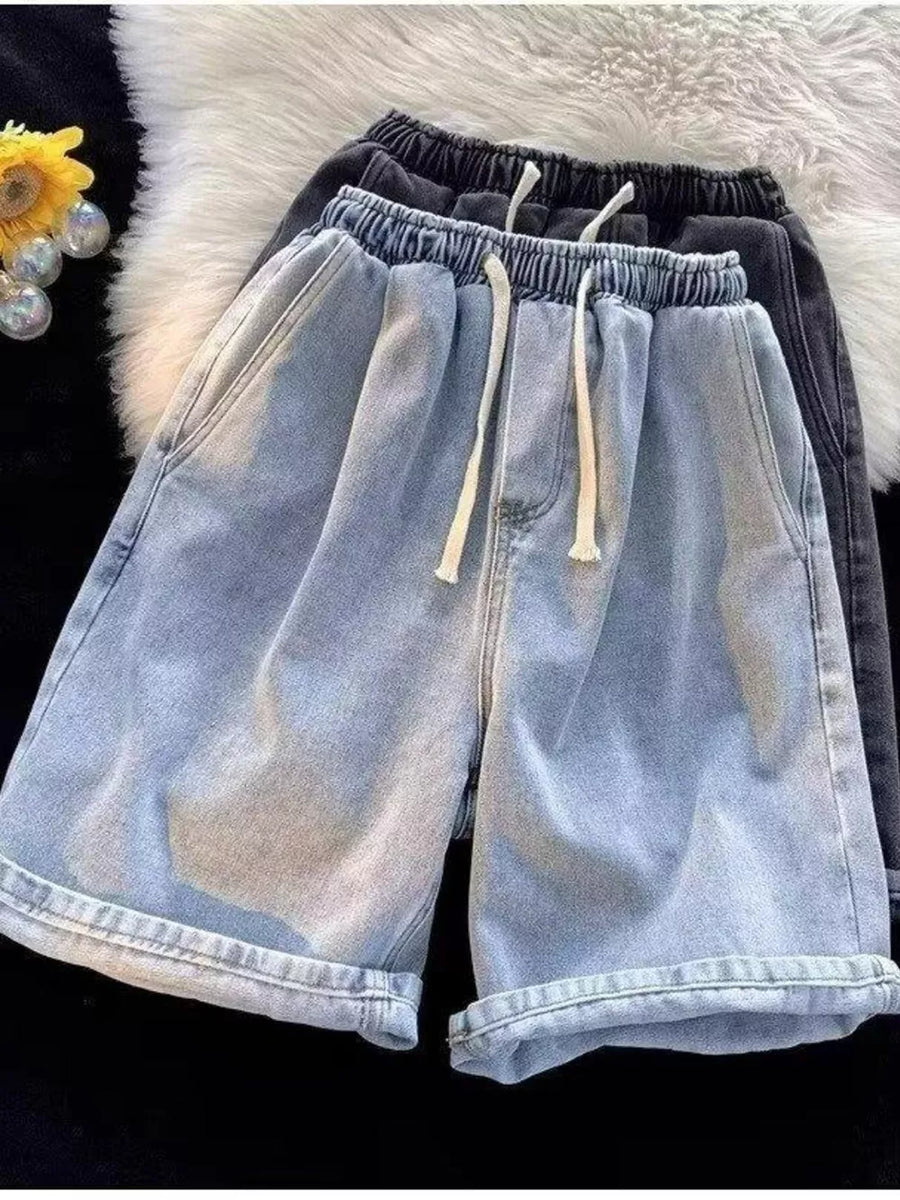Men's light wash relaxed fit denim shorts with drawstring waist and cuffed hems.