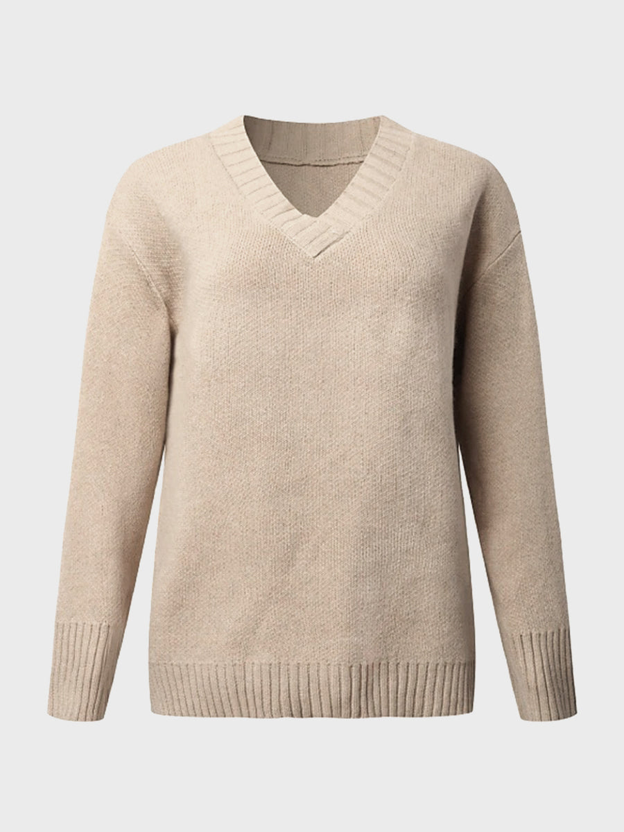 Tan knit sweater with V-neck and ribbed trim details.