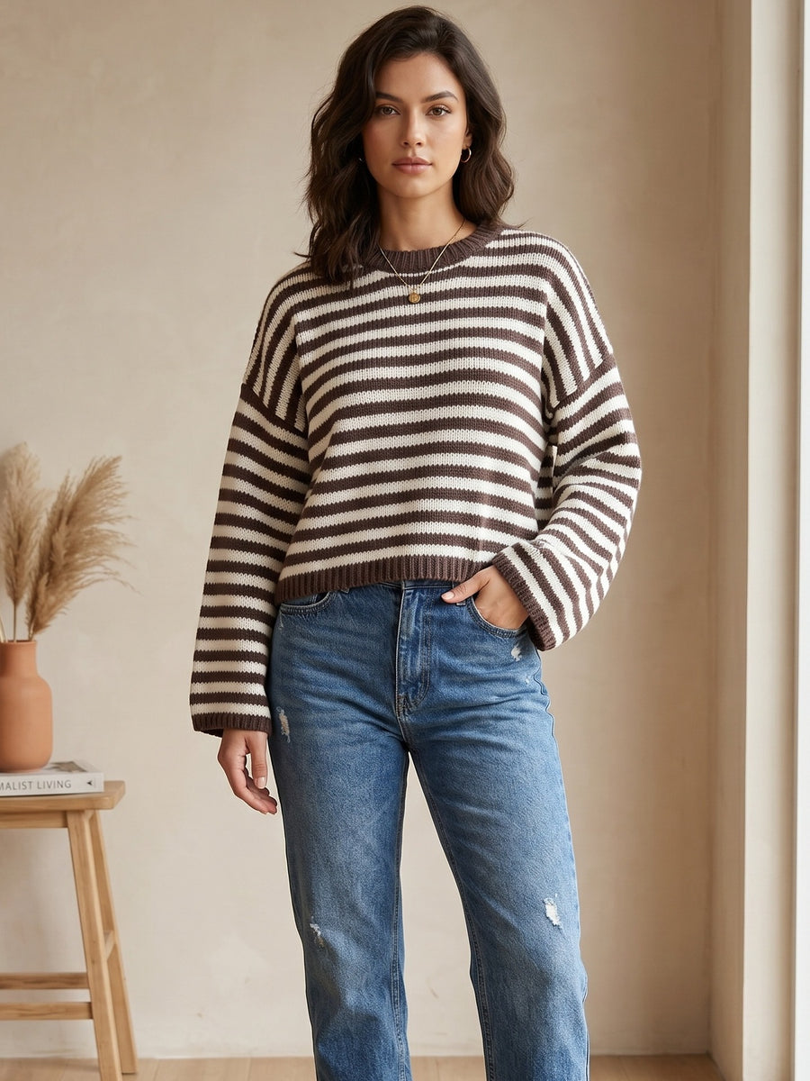 light pink crewneck sweater with ribbed cuffs and long sleeve