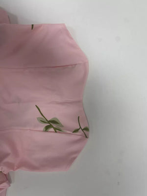 Blush pink tube maxi dress with a delicate green floral print.