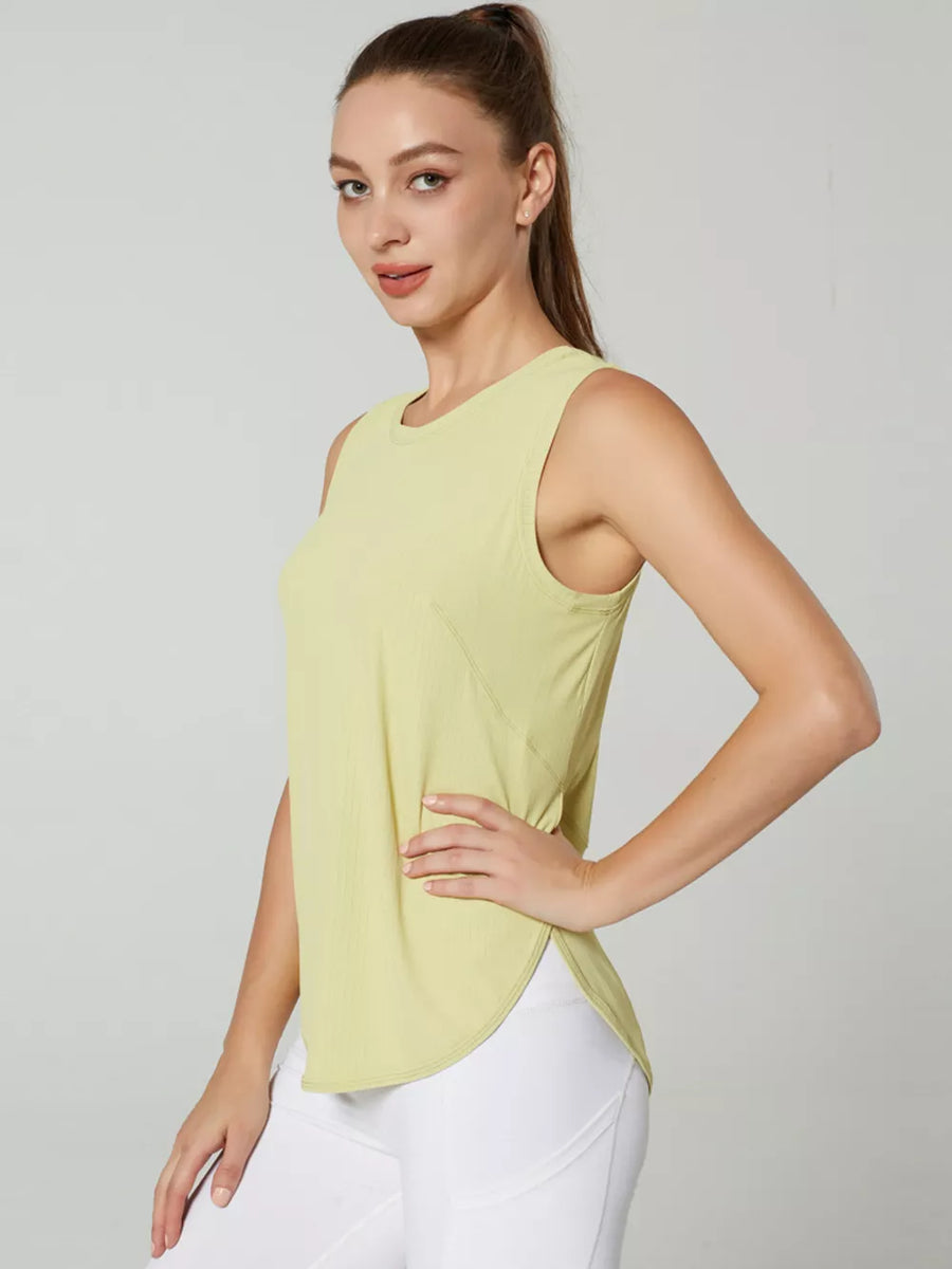 Women's light yellow sleeveless athletic tank top with curved hem
