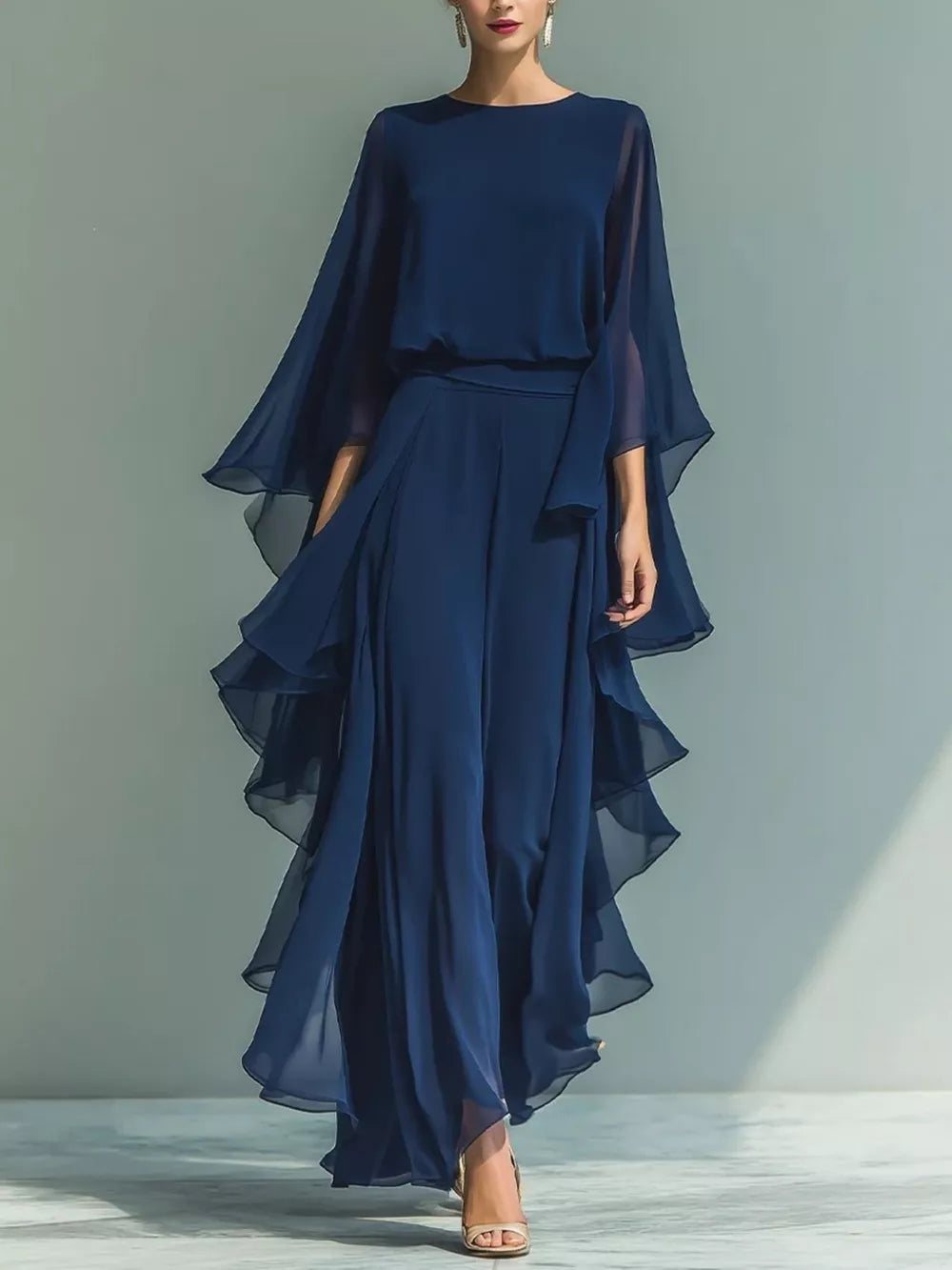 Navy blue chiffon maxi dress with cape sleeves and tiered ruffled skirt.