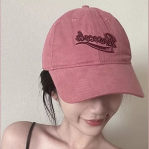 Vintage washed cotton baseball cap in raspberry powder with embroidered text detail.