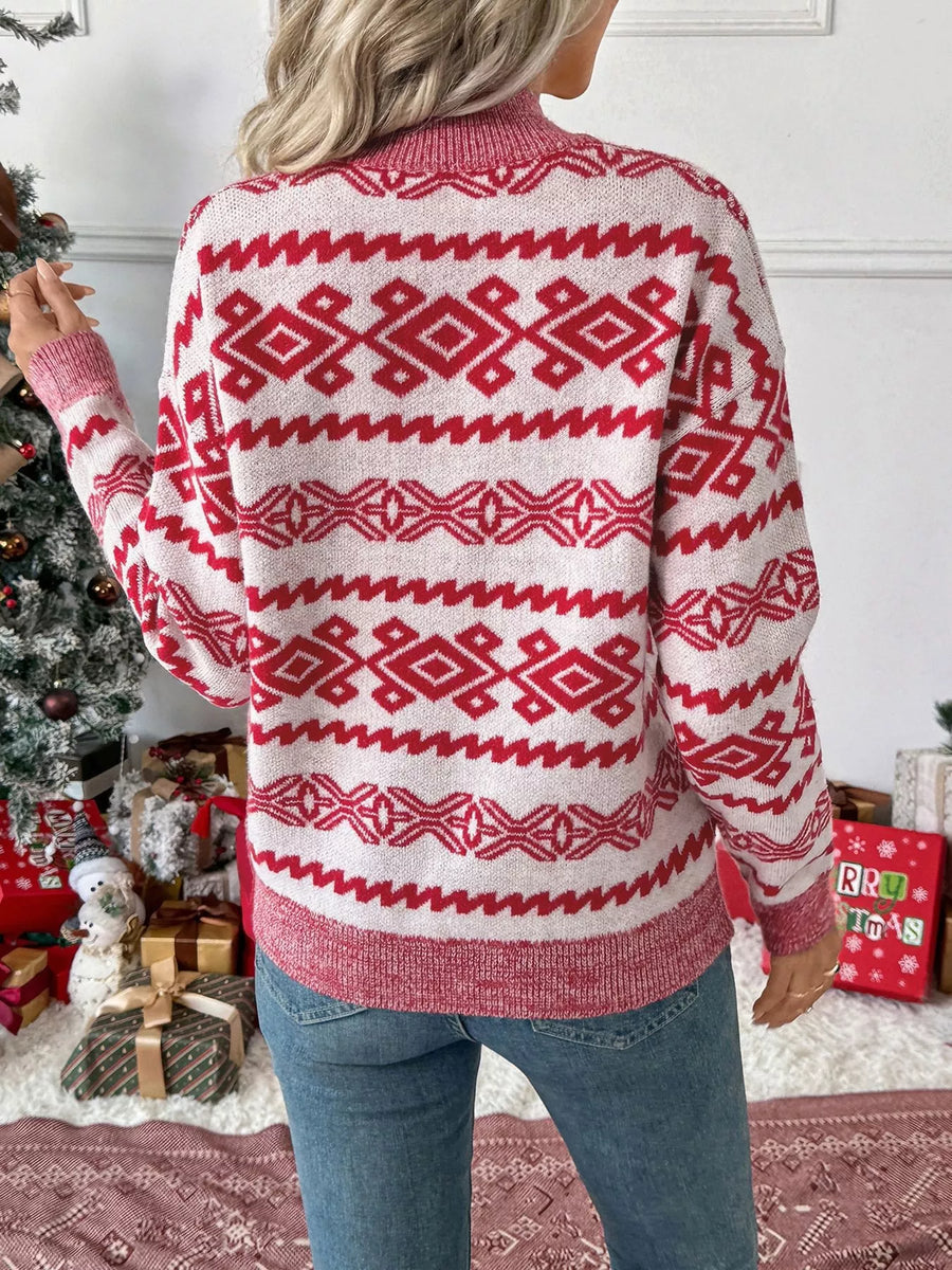 Red and white patterned long-sleeve sweater with a round neck.