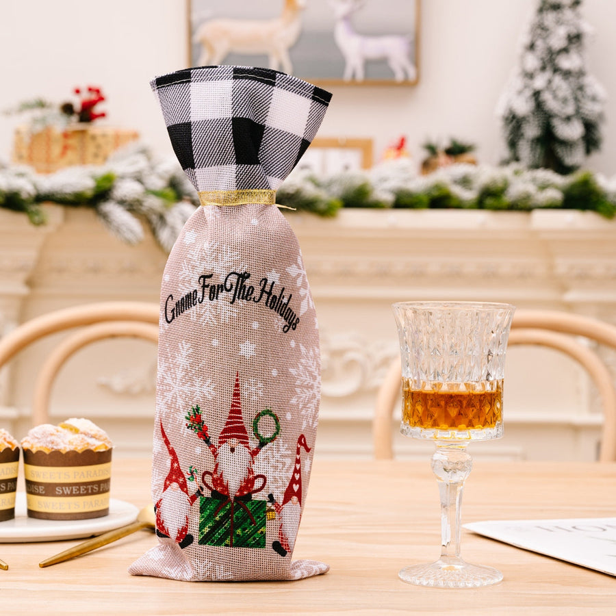 Festive gnome plaid bottle cover with "Gnome For The Holidays" text and snowflakes.