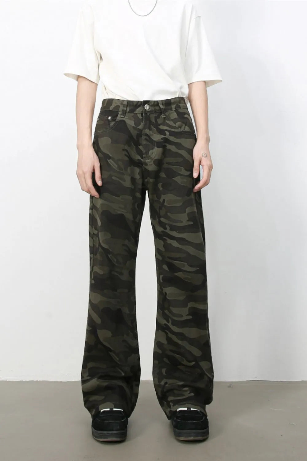 Camo flare denim trousers in green camouflage pattern.