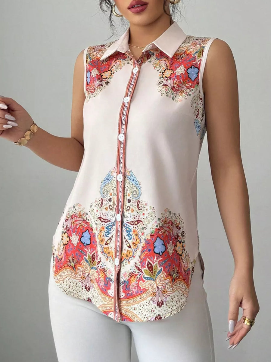 Sleeveless collared shirt in white with vibrant paisley print and button front.