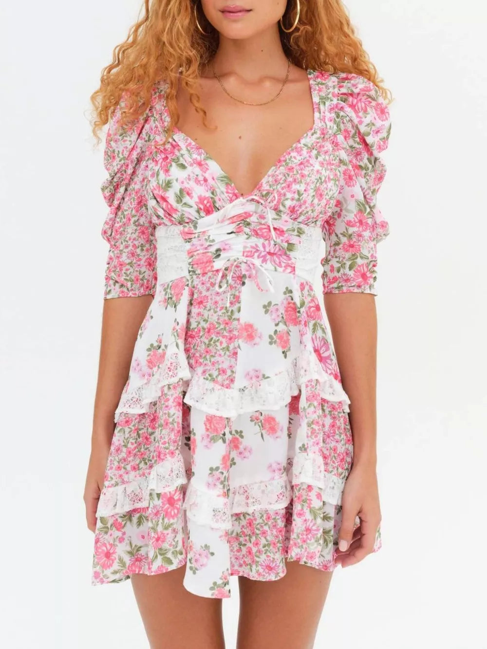 Pink floral tie-front dress with ruched half sleeves and tiered lace trim skirt.