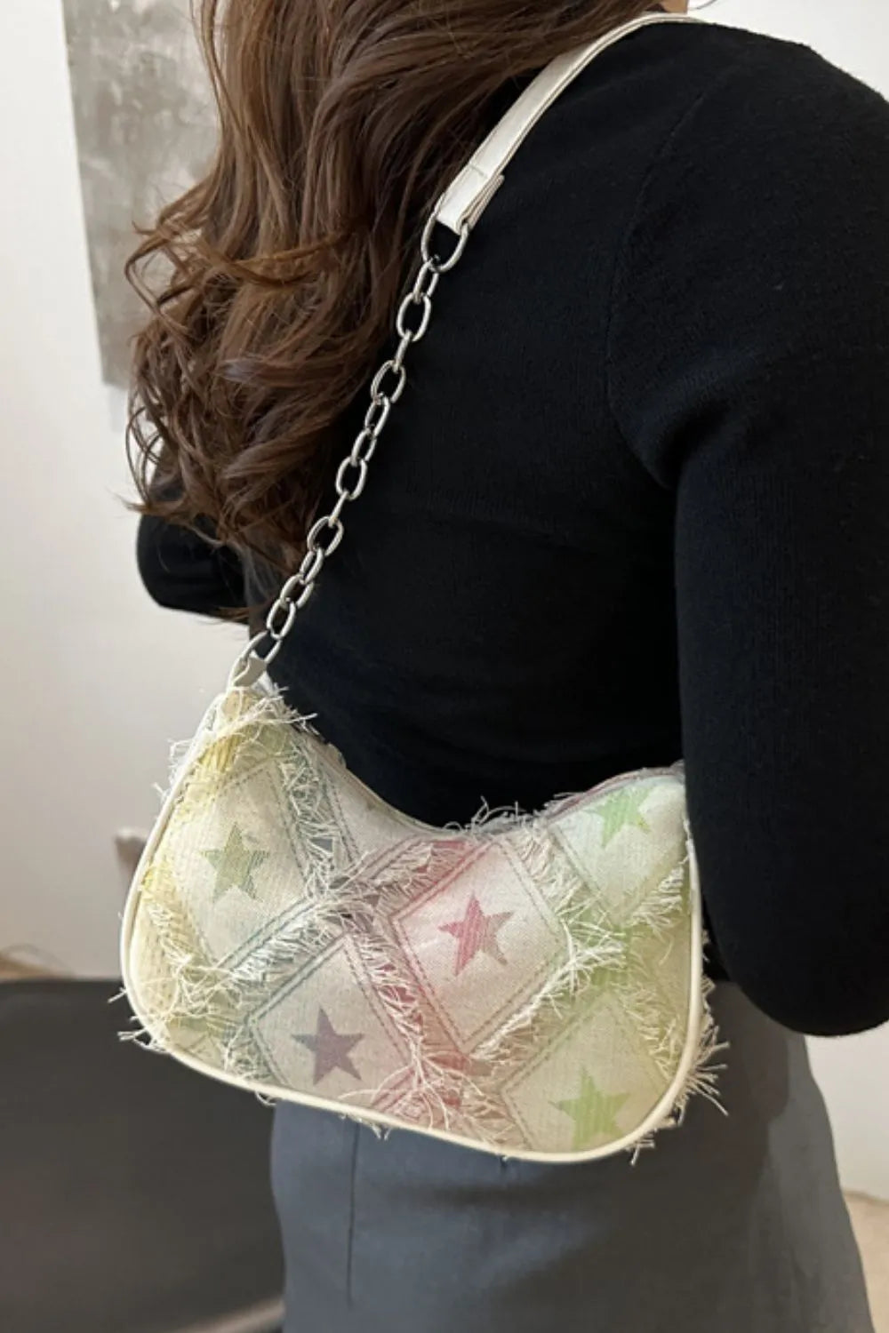Rainbow starburst denim shoulder bag with frayed edges and chain strap