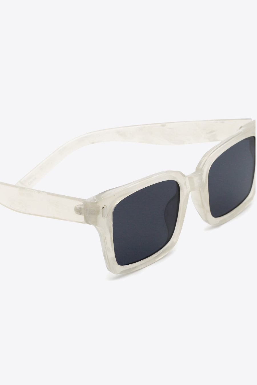 Marble effect rectangular sunglasses with dark lenses and transparent frames.