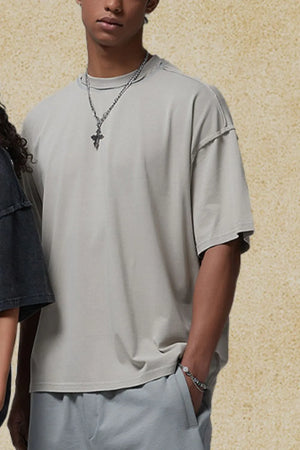 Beige washed cotton tee with raw seams and a crew neck.