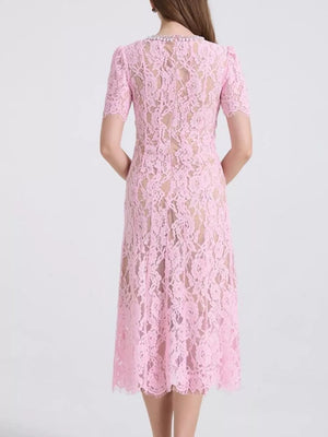 Pink lace midi dress with pearl-embellished neckline and short sleeves.
