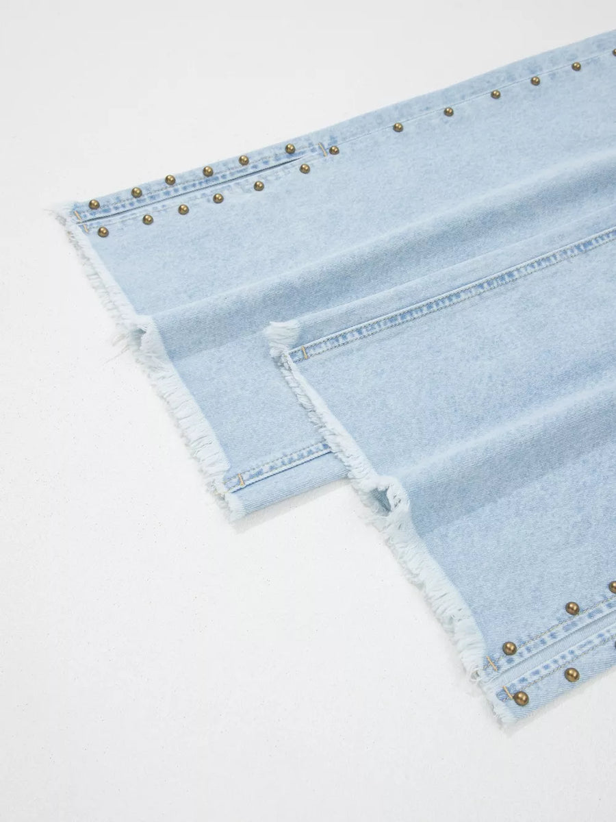 Light wash denim wide-leg jeans with studded side slits and frayed hem.