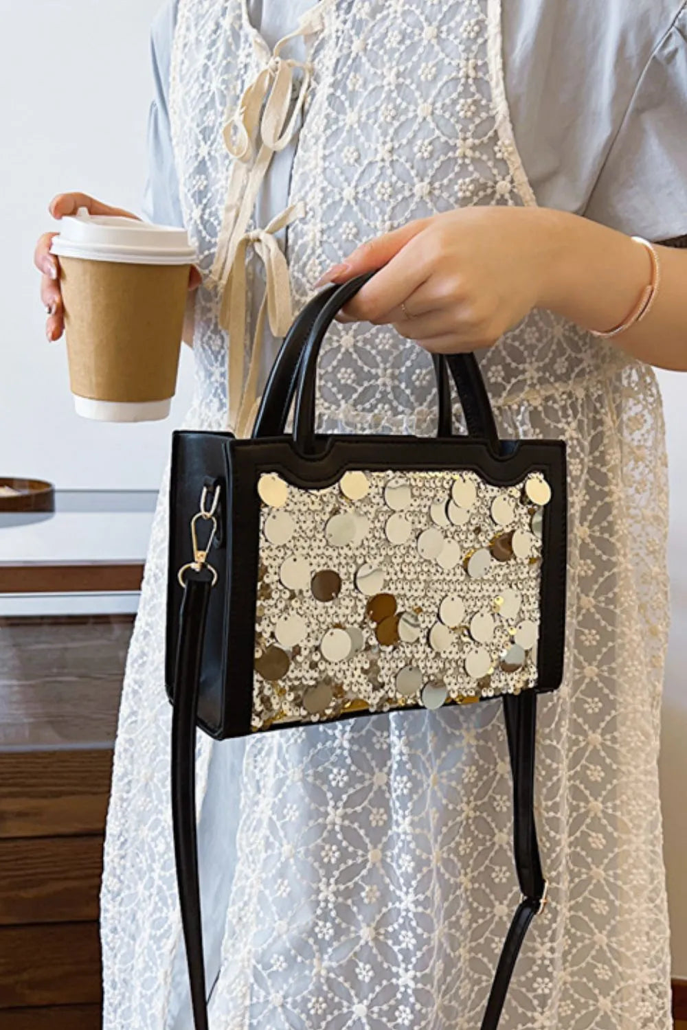Black mini bag with sequin embellishments and structured top handles