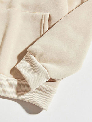 Cream hoodie with ribbed cuffs and hem, featuring a front pocket detail.