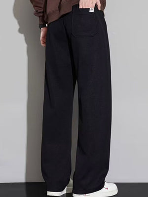 Men's black casual loose fit drawstring sweatpants with a back pocket detail.