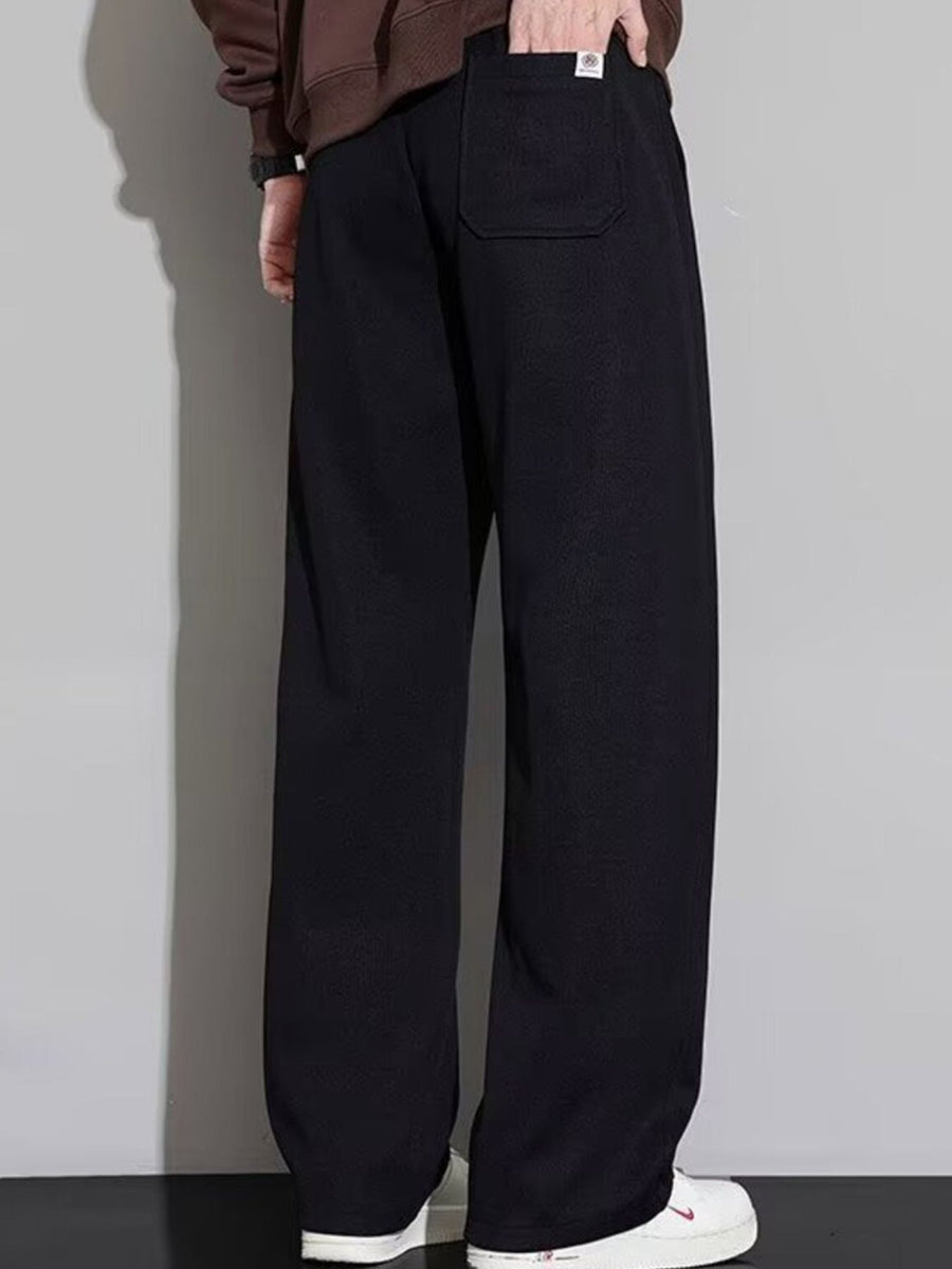 Men's black casual loose fit drawstring sweatpants with a back pocket detail.