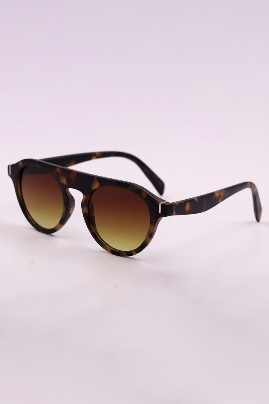 Round tortoiseshell sunglasses with gradient brown lenses and gold accents