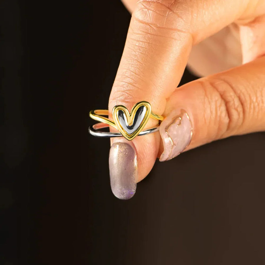 Two-tone gold heart outline ring with double band detail.