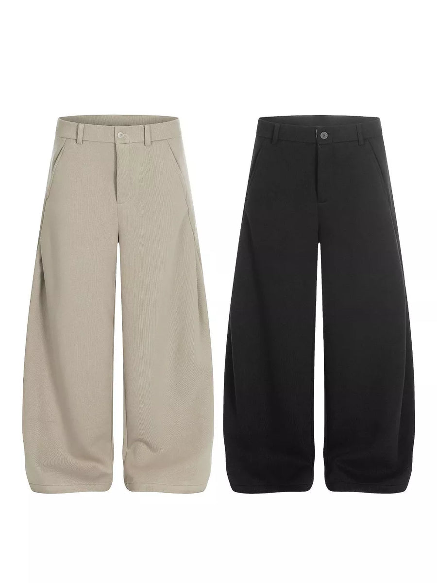 Men's relaxed fit sweatpants in black and apricot with pockets.