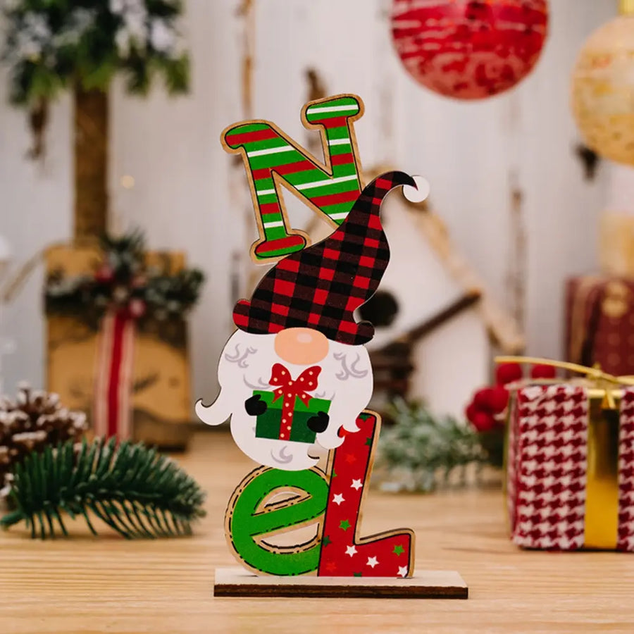Wooden holiday decor trio spelling NOEL with a gnome holding a gift
