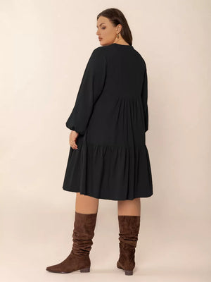 Plus-size black balloon sleeve tiered dress with button front detail.